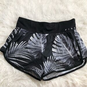 Pink workout shorts with grey leaves design. Worn few times. Size medium running